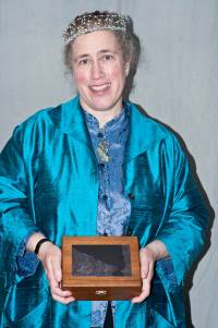 Greer Gilman in blue with her Tiptree Award